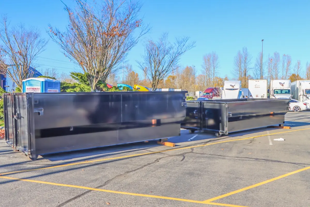 Professional dumpster rental service with roll-off container on residential driveway in Herriman